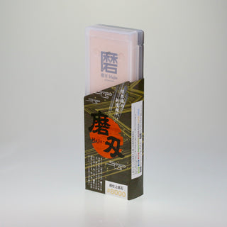 Schräge Aufsicht auf die stehende Verpackung des japanischen Schleifsteins Togi 8000, bestehend aus einer transparenten Kunststoffbox und einer bedruckten Banderole.